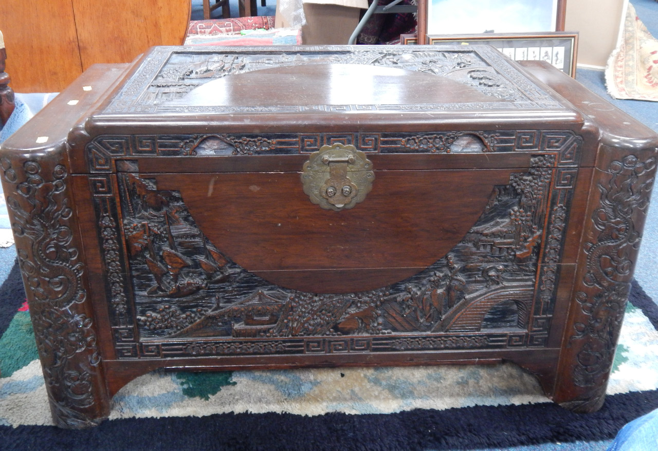 Appraisal: A camphorwood blanket chest with relief carved oriental scenes and