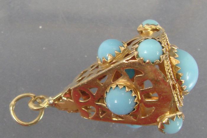 Appraisal: K yg Pendant Hollow with cutwork contains nine turquoise colored