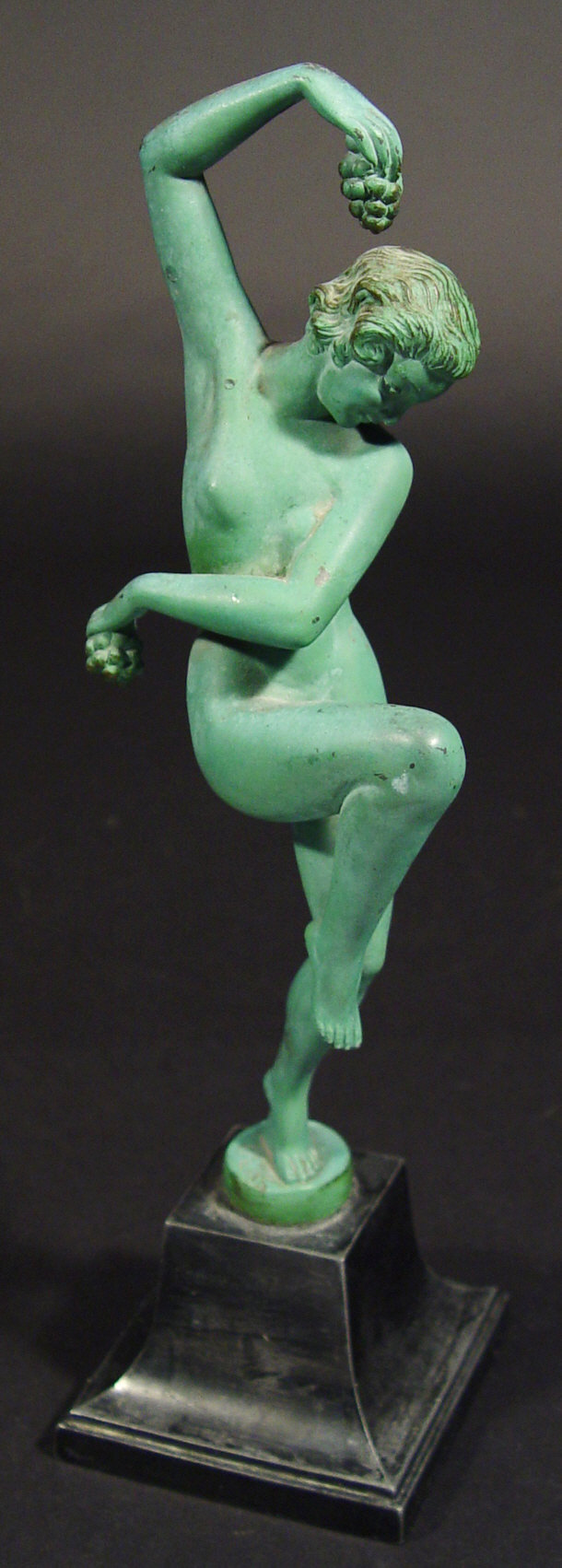 Appraisal: Art Deco cast metal nude figurine clutching grapes on a