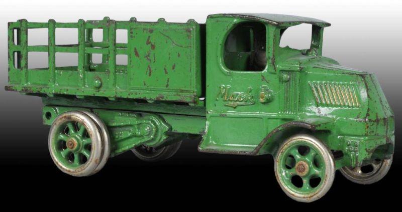 Appraisal: Cast Iron Arcade Mack Stake Truck Toy Description Green with