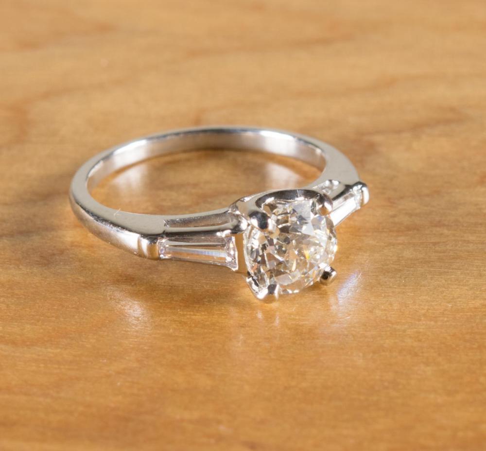 Appraisal: DIAMOND AND PLATINUM THREE-STONE RING with a pair of diamond