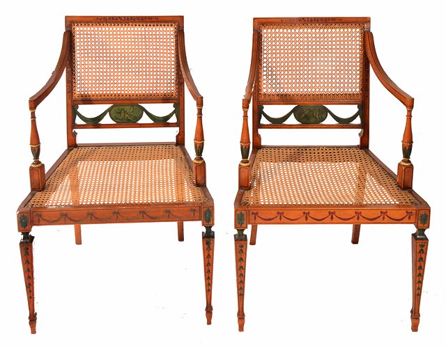 Appraisal: A PAIR OF EDWARDIAN SATINWOOD AND CANE SEATED OPEN ARMCHAIRS