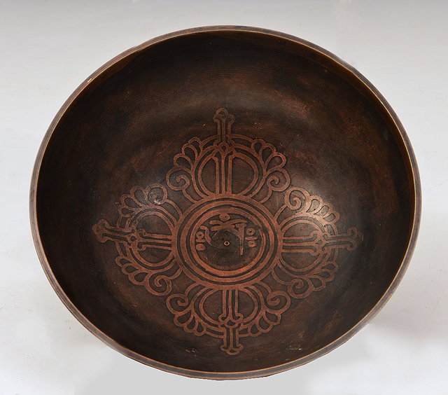 Appraisal: A TIBETAN BRONZE PATRA inlaid with a central design in