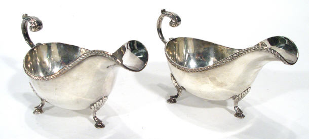 Appraisal: Two silver plated sauce boats on cabriole feet cm long