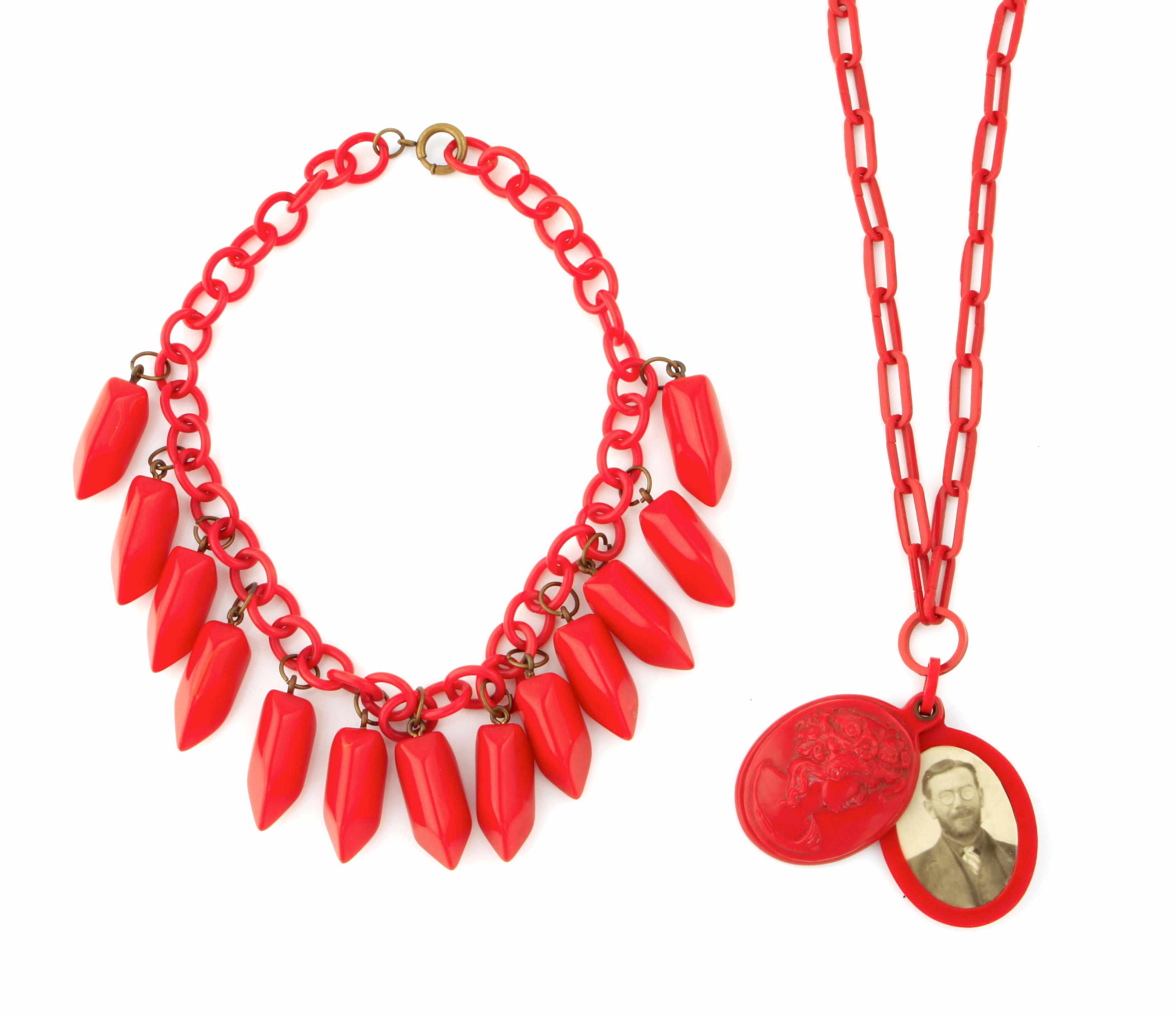 Appraisal: Two red Bakelite necklaces fringe pepper and cameo locket with