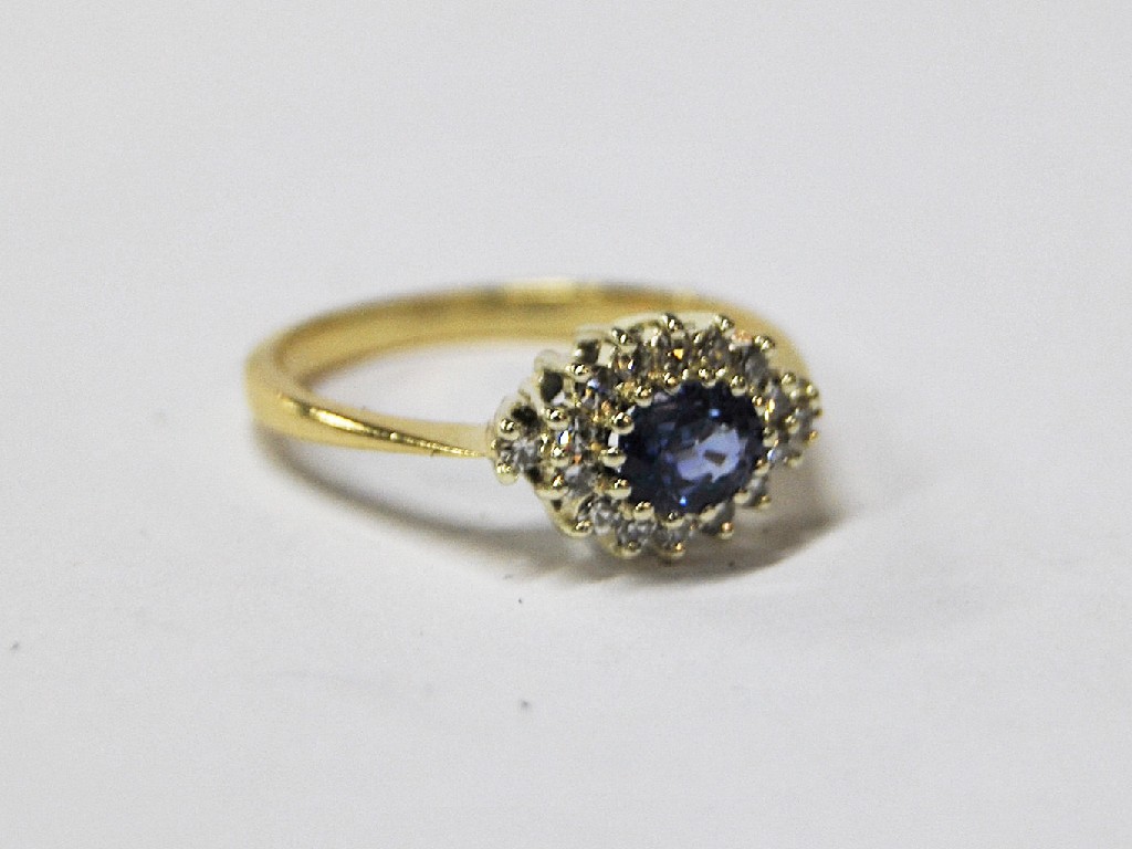 Appraisal: Oval cluster ring the central oval sapphire surrounded by fourteen