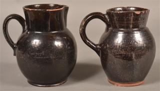 Appraisal: PA Manganese Glazed Redware Pitchers Two Pennsylvania th Century Manganese