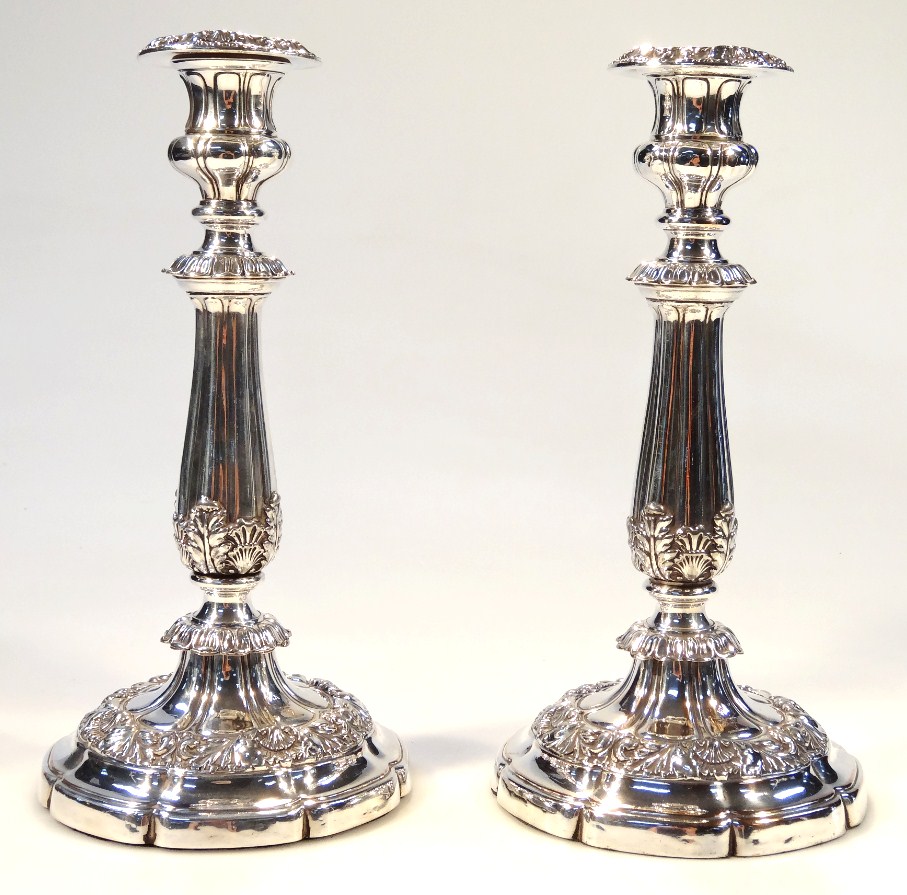 Appraisal: A pair of silver plated candlesticks each with heavily embossed