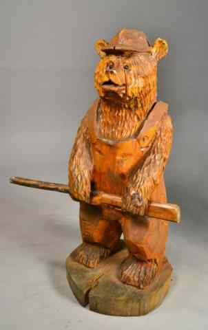 Appraisal: HAND CARVED WOODEN BEAR WITH GUNDepicting standing bear holding a