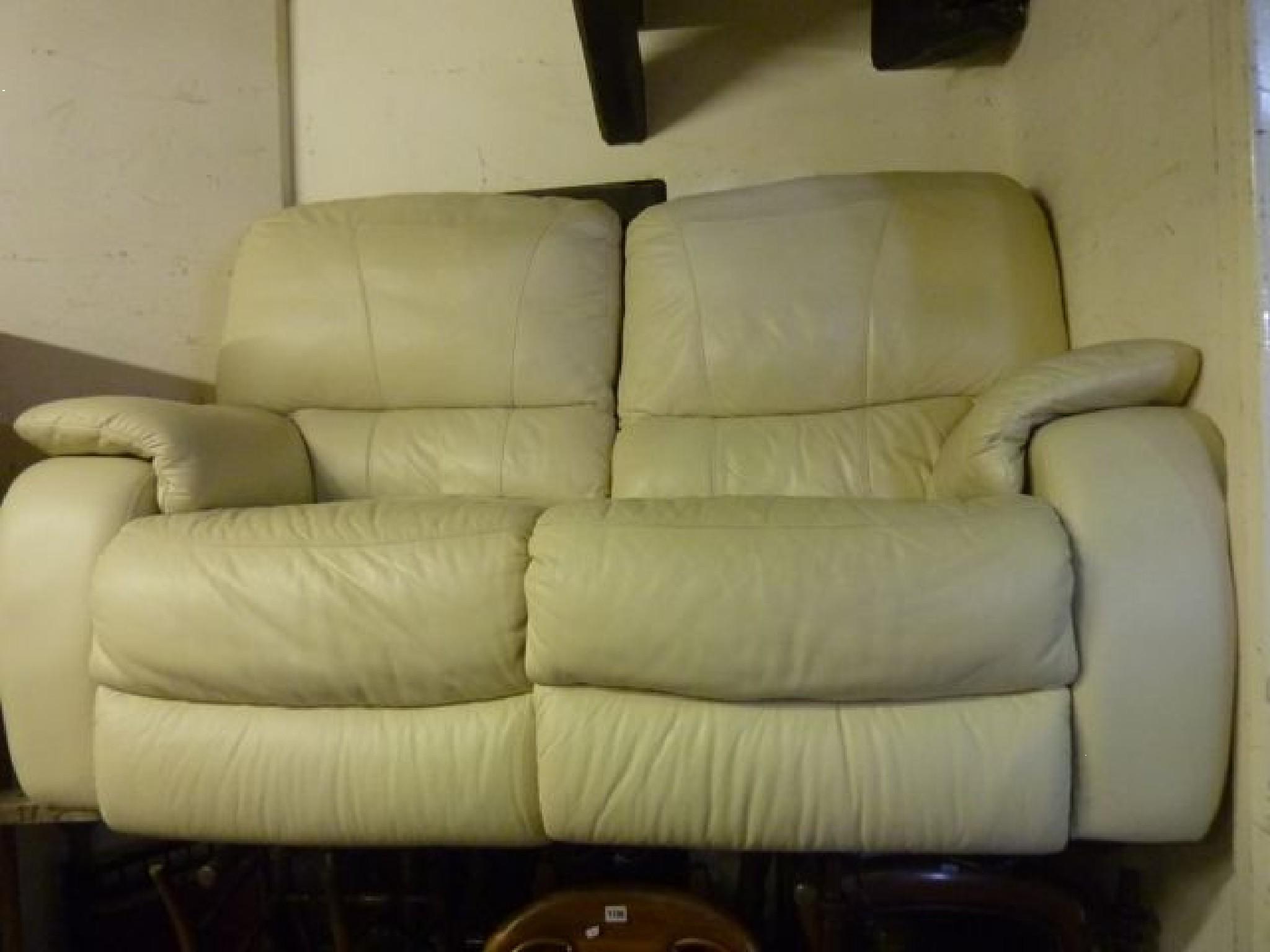 Appraisal: A contemporary cream leather upholstered two section two seat reclining