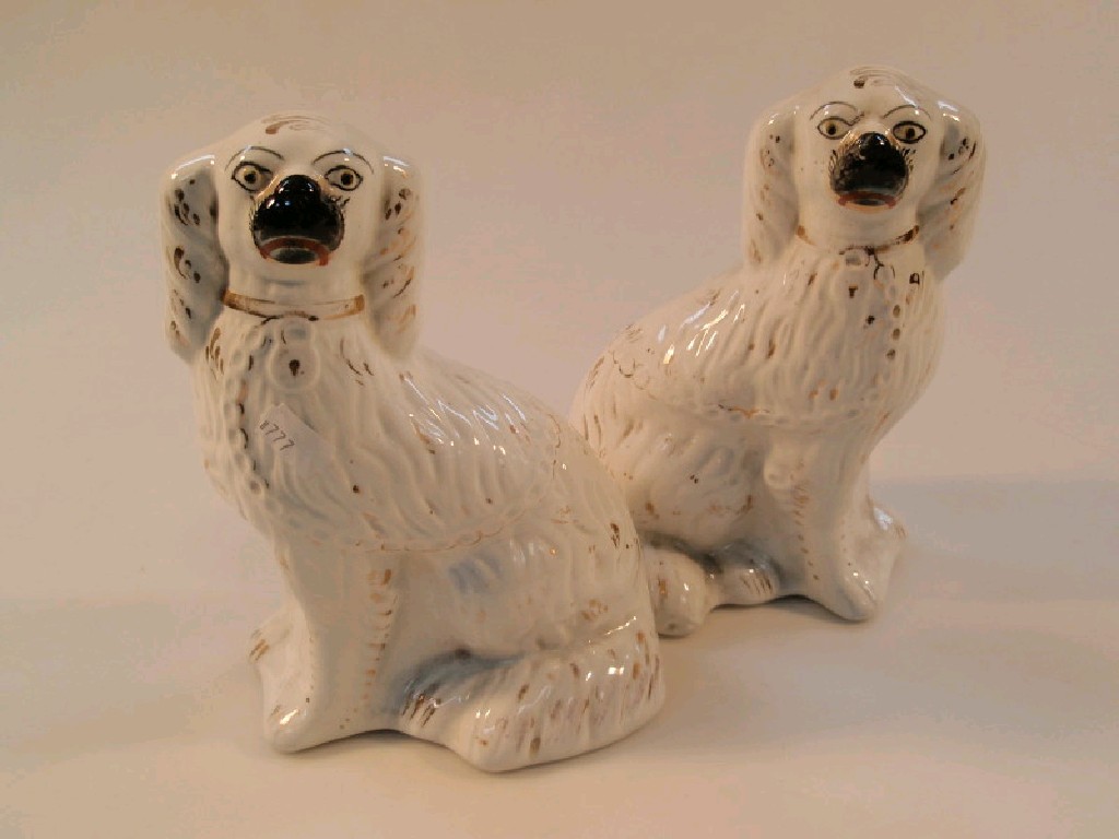 Appraisal: A pair of late thC Staffordshire pottery spaniels with black