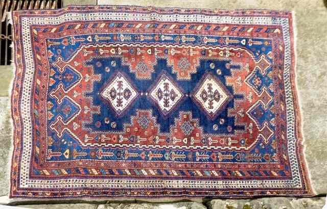 Appraisal: A CAUCASIAN BLUE GROUND RUG with central medallions and multiple