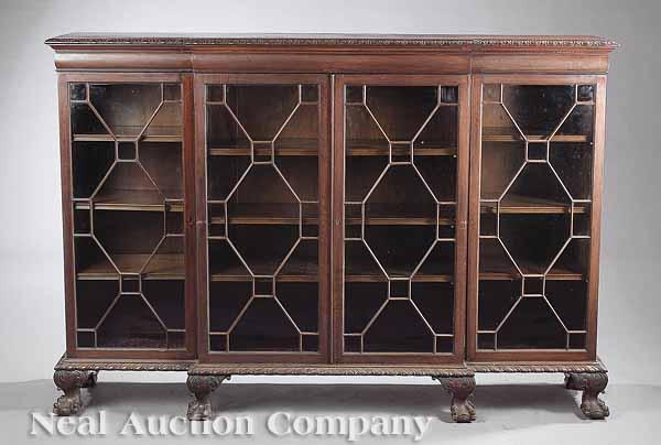 Appraisal: An English Carved Mahogany Breakfront Bookcase c the foliate molded