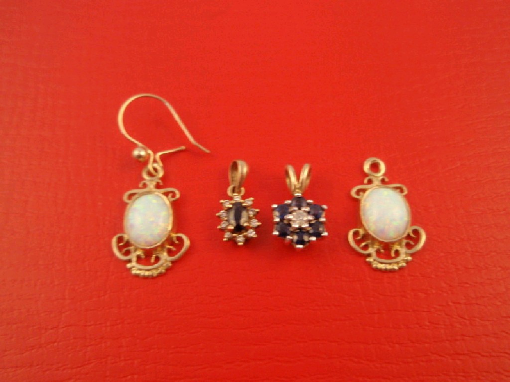 Appraisal: A pair of opal set earrings one wire missing and