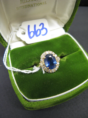 Appraisal: SAPPHIRE DIAMOND AND FOURTEEN KARAT GOLD RING centering an oval-cut