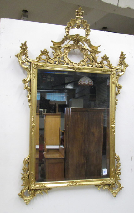 Appraisal: ROCOCO STYLE GILTWOOD WALL MIRROR imported from Italy by La