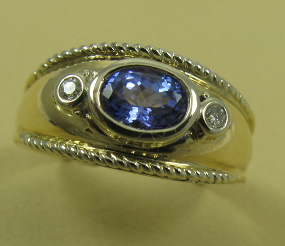 Appraisal: TANZANITE DIAMOND AND FOURTEEN KARAT GOLD RING centering an oval-cut