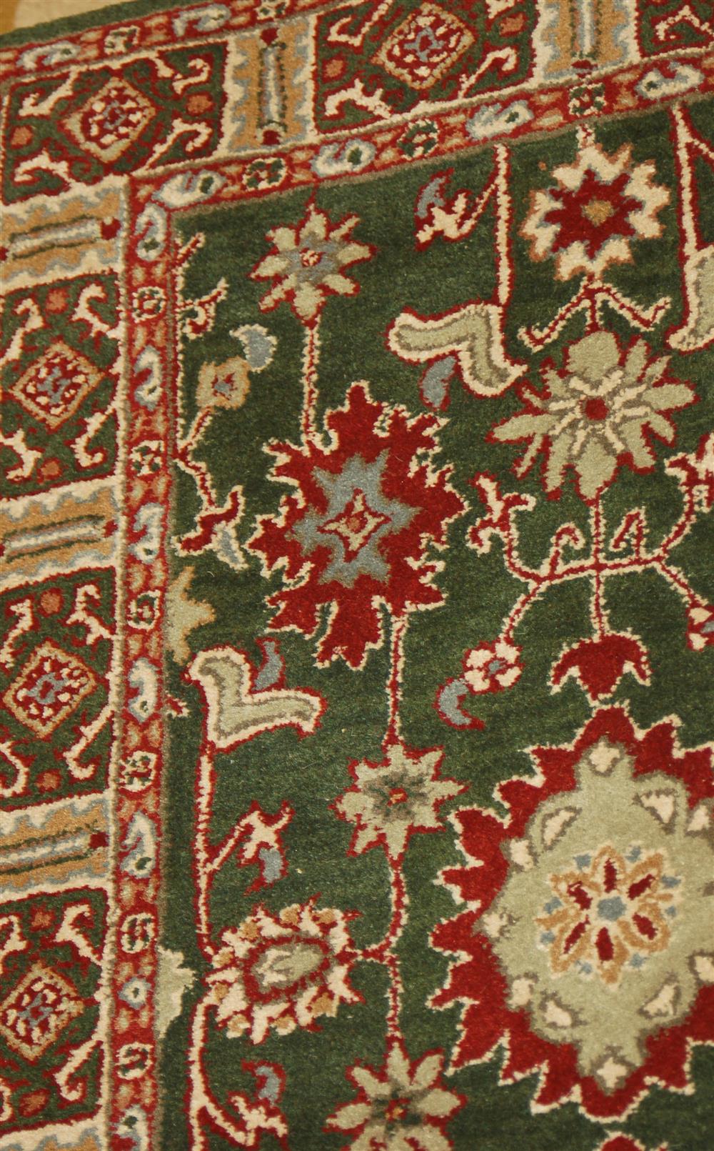 Appraisal: GREEN AND BURGUNDY LOOMED WOOL AREA RUG