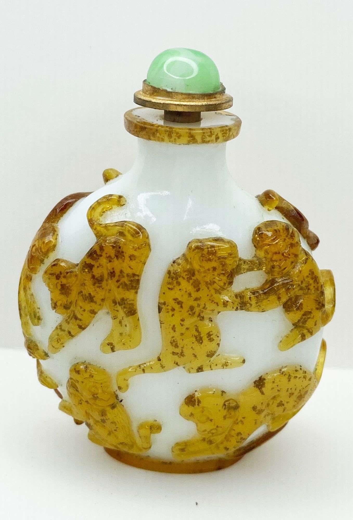 Appraisal: Chinese Peking Glass Carved Monkeys Snuff Bottle tall at widest