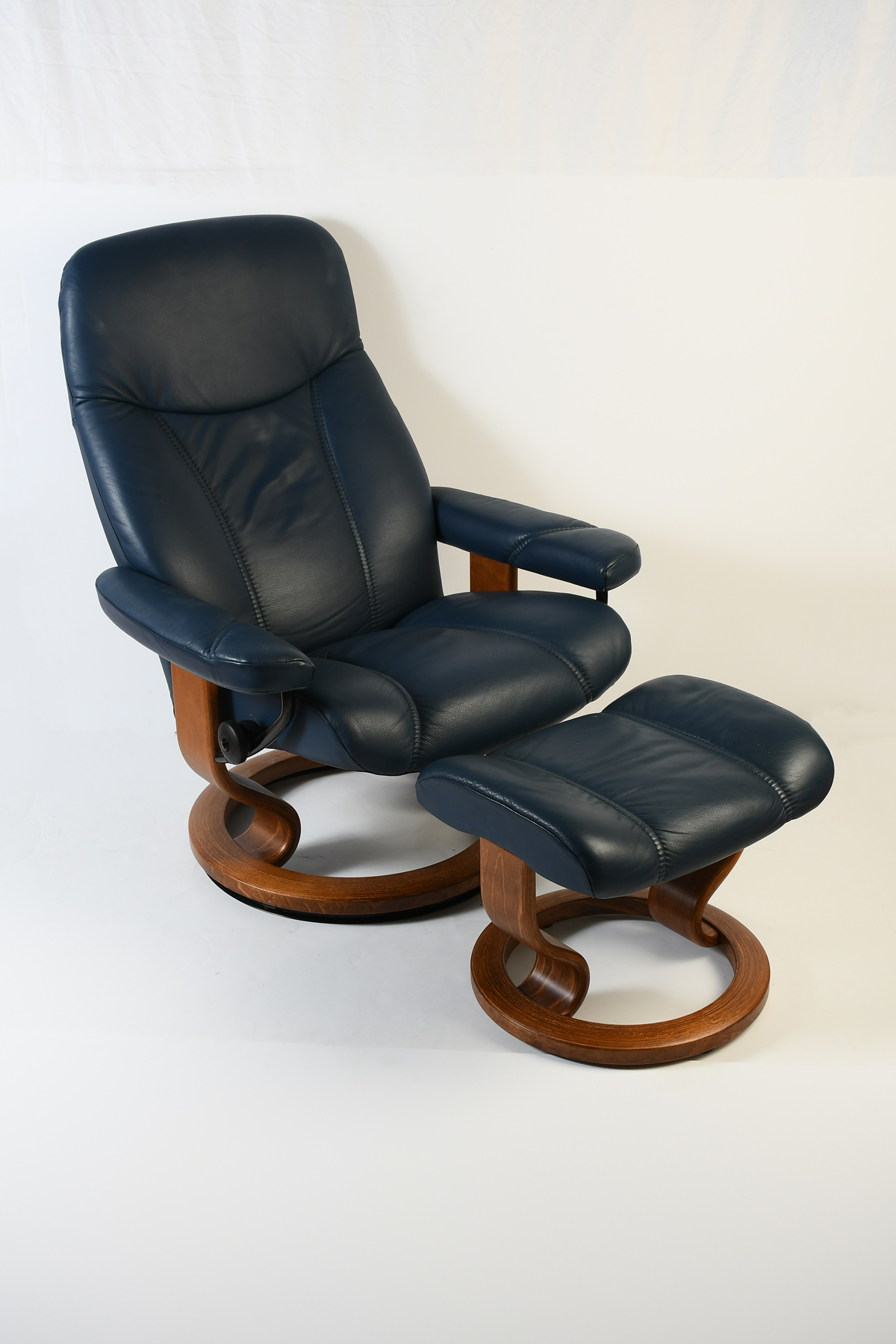 Appraisal: BLUE LEATHER EKORNES CHAIR OTTOMAN Swiveling reclining Ekornes Stressless chair