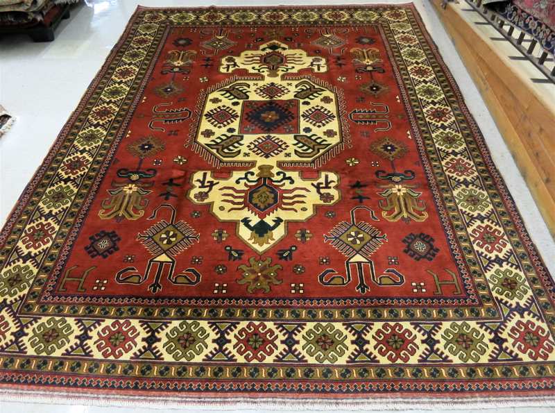 Appraisal: HAND KNOTTED ORIENTAL CARPET Pakistani Persian tribal geometric central medallion