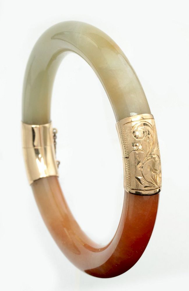 Appraisal: A JADE BANGLE BRACELET WITH K YELLOW GOLD MOUNTS The