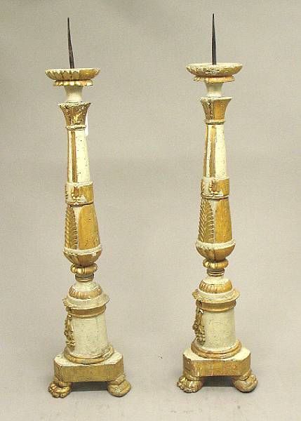 Appraisal: A pair of Italian Neoclassical painted and parcel gilt prickets