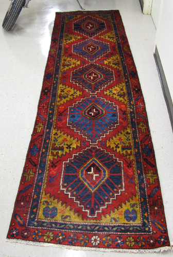 Appraisal: PERSIAN HAMADAN RUNNER hand knotted in a five geometric medallion