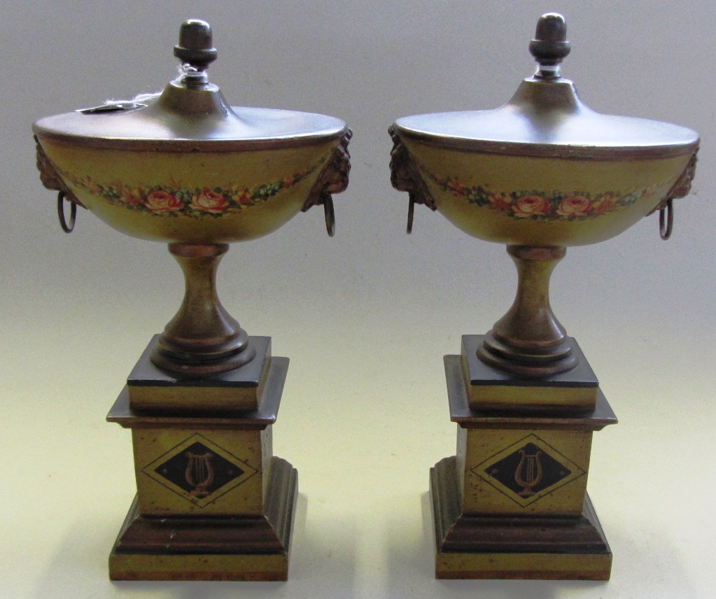 Appraisal: A pair of Regency style chestnut urns with acorn finials