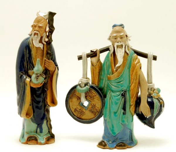 Appraisal: A pair of large Chinese mud figures One figure depicting