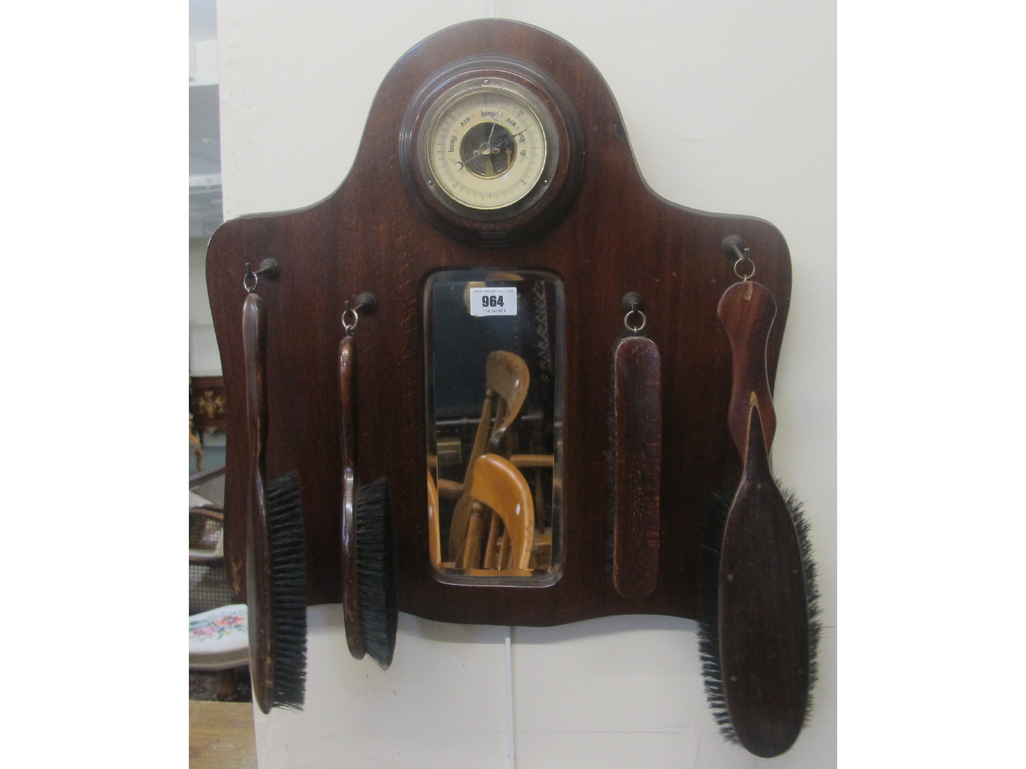 Appraisal: A mahogany brush set on wall hanging with barometer