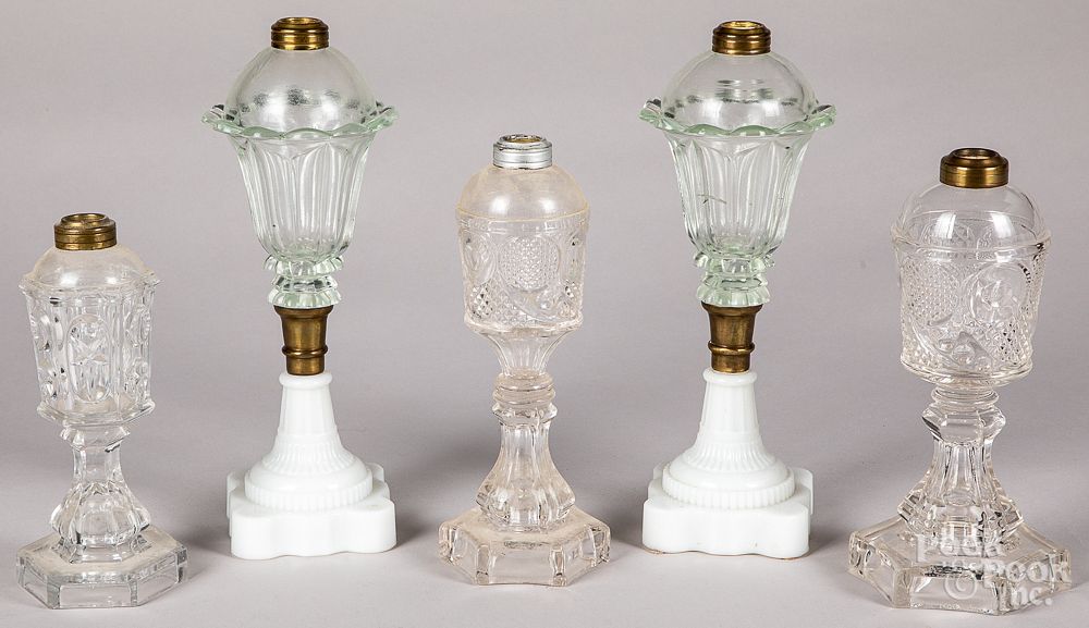 Appraisal: Five colorless and clambroth glass fluid lamps Five colorless and