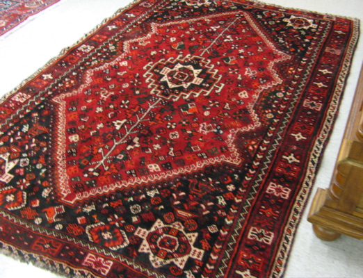 Appraisal: PERSIAN SHIRAZ CARPET hand knotted in a central geometric medallion