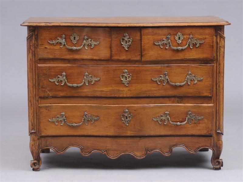 Appraisal: LOUIS XV PROVINCIAL BRONZE-MOUNTED CARVED WALNUT COMMODE The serpentine-fronted case