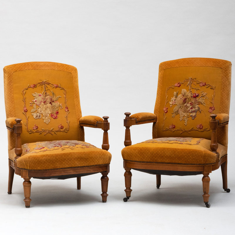 Appraisal: PAIR OF CONTINENTAL WALNUT UPHOLSTERED ARMCHAIRS Each with appliqu d