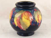 Appraisal: A Moorcroft leaf and berry pattern globe vase on a