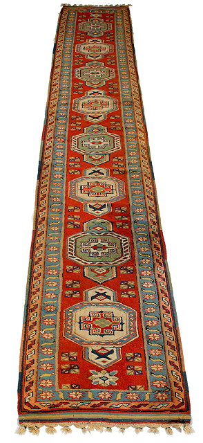 Appraisal: A MIDDLE EASTERN POLYCHROME RUNNER with a banded border geometric