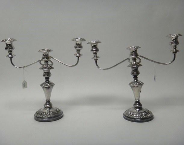 Appraisal: A pair of plated three light table candelabra each with