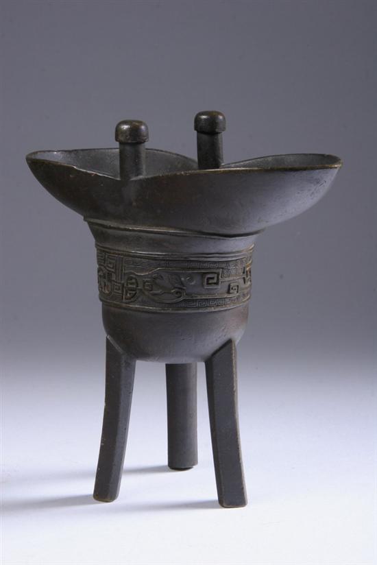 Appraisal: CHINESE BRONZE TRIPOD VESSEL Qianlong mark With stylized taotie frieze