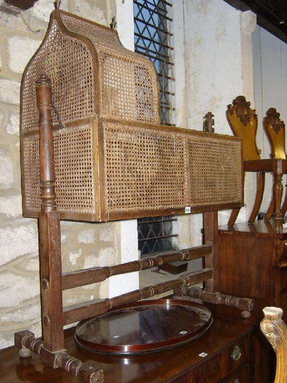 Appraisal: A th century mahogany framed cradle with arched canopy and