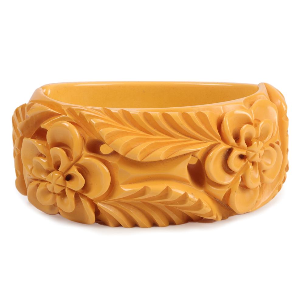 Appraisal: BAKELITE WIDE BUTTERSCOTCH CLAMPER BRACELET WITH DEEPLY CARVED FLORAL MOTIF