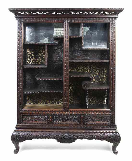 Appraisal: A Chinese Carved Display Cabinet having a pierce carved overhanging