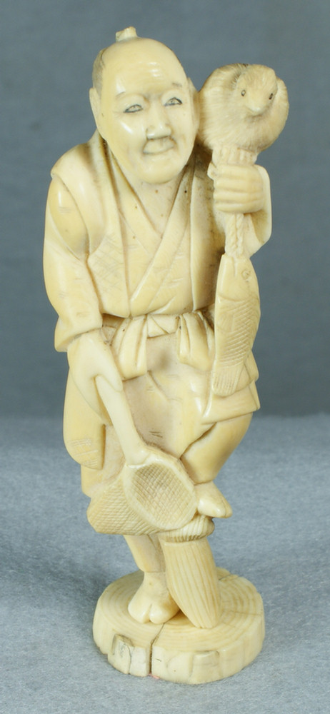 Appraisal: Japanese carved ivory fisherman with net and fish loose from