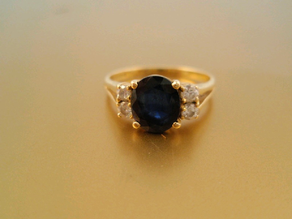 Appraisal: A sapphire and diamond cluster ring the central faceted oval