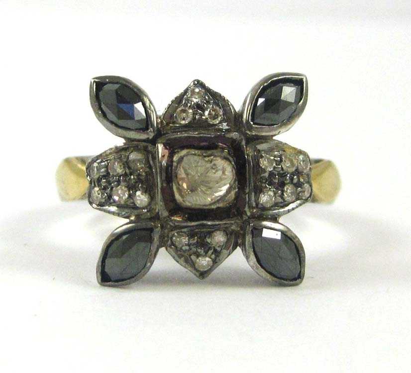 Appraisal: DIAMOND SILVER AND YELLOW GOLD RING The sterling silver and