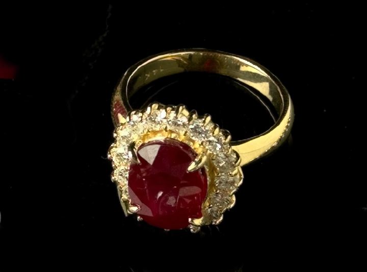 Appraisal: Fourteen-Karat Ruby and Diamond Dinner Ring containing one prong-set oval