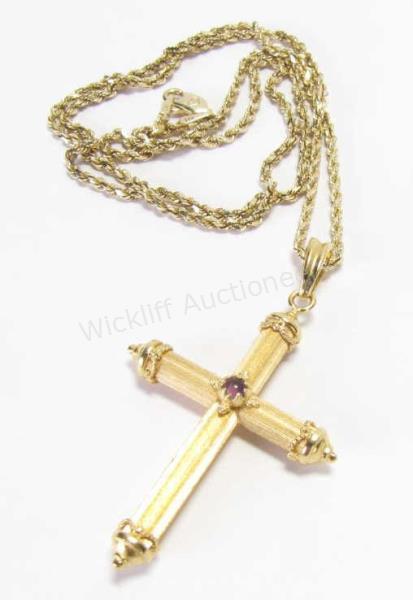 Appraisal: An K satin finished yellow gold cross pendant with cabochon