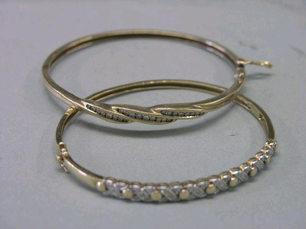 Appraisal: Two ct gold bangles each set with small diamonds