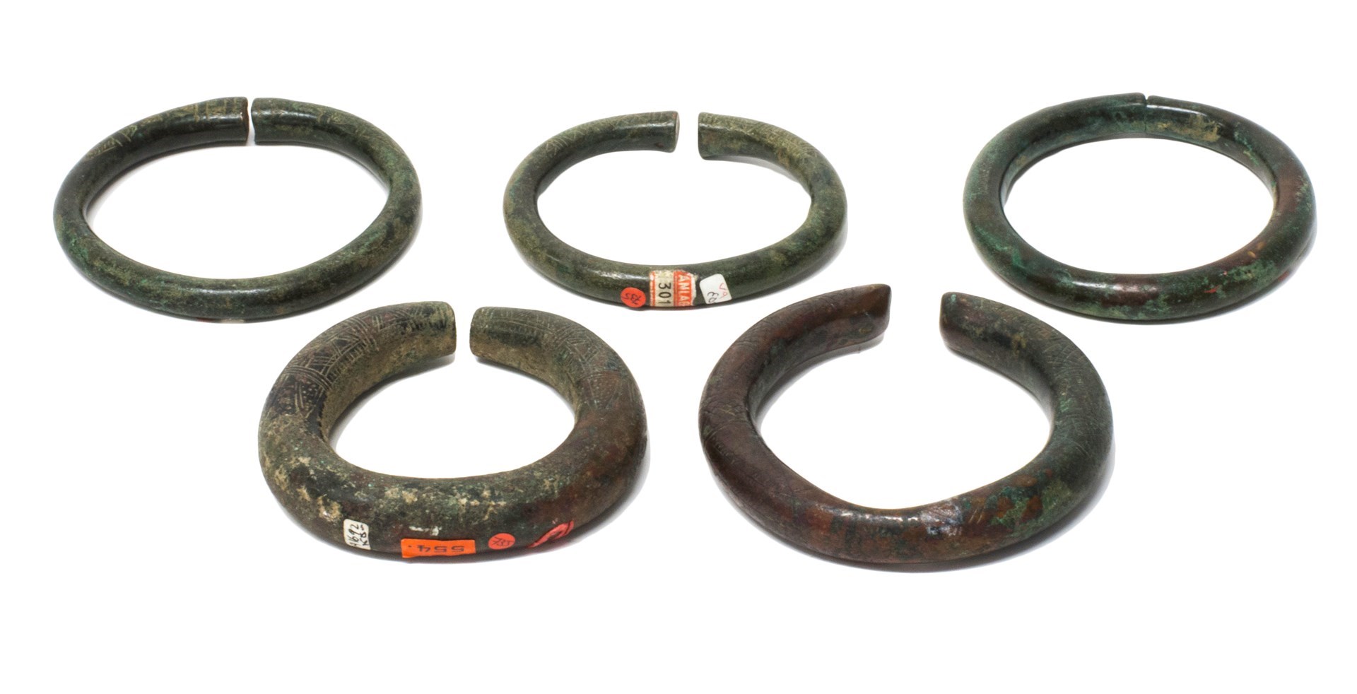 Appraisal: A group of five Luristan bronze bangles one plain the