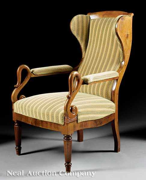 Appraisal: A Charles X Fruitwood Fauteuil Oreilles th c winged back